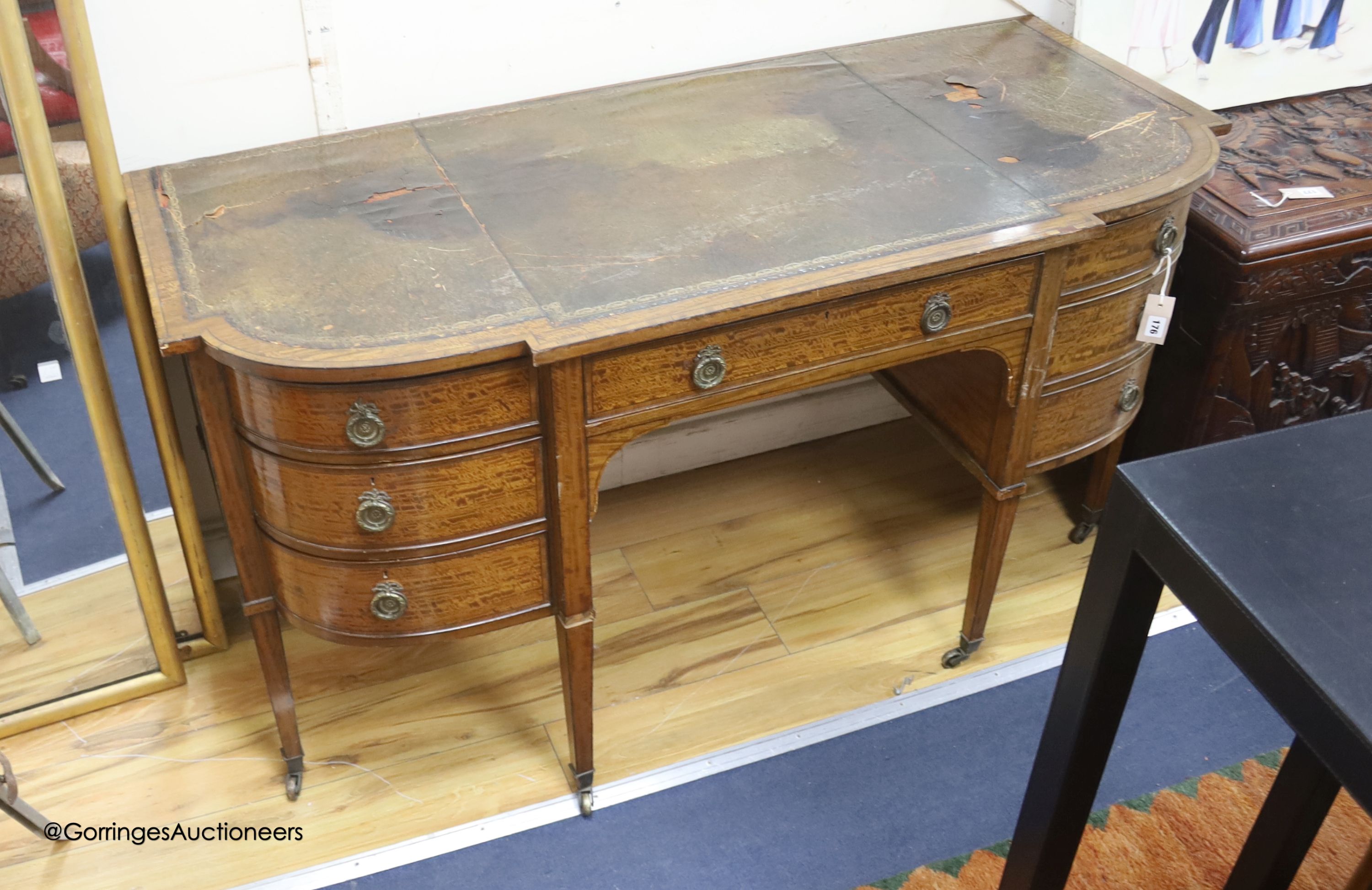 An Edwardian banded breakfront kneehole desk, length 142cm, depth 63cm, height 75cm